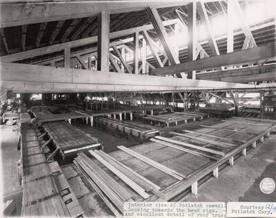 A photograph of the inside of Potlatch Sawmill looking towards the head rigs with excellent detail of the roof.