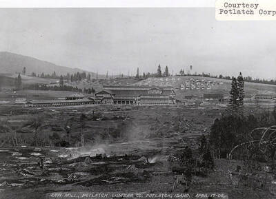 A photograph of the Potlatch Lumber Company's sawmill with a view of a developing Potlatch, Idaho behind it.
