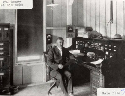 A photograph of Wm. Deary at his desk.