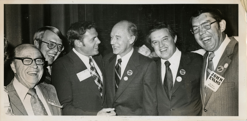 Photo Description: 6 democratic officers are all smiling at each other and posing for a picture. Text back translation "all Democratic State Constitutional Officers'; Auditor Joe R. Williams; Attorney General Tony Park; Superintendent of Public Instruction Roy Truby; Governor Cecil D. Andrus; Senator Frank Church; Lt. Governor John V. Evans" Notes read on back "Thurs 4 x 3 1/2 wide most of the top echelon"