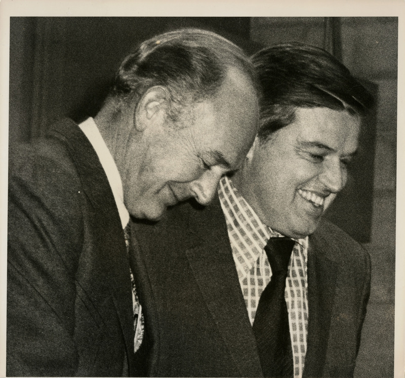 Photo Description: Governor Andrus and Senator Church are smiling toward the ground. Text back translation "Governor Cecil D Andrus Senator Frank Church" Notes read on back "2x3 1/2; Page A-12; At Loggerheads