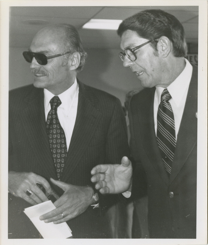 Photo Description: John Evans and Utah Governor Scott Matheson are looking to the left and talking.