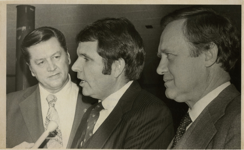 Photo Description: Idaho republican senators Steve Symms and James McClure are talking with 2nd District Idaho Congressman George V. Hansen as they get interviewed by a person off camera. Notes read on back "Page B-7 4x4 3/4 Idaho's Republicans 98"