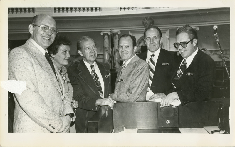 East Idaho legislators Paxman, Kearnes, Miller, Hammond, Sessions, and Bateman are all smiling and posing for a picture. Notes read on back "Sunday feature 4x4 East Idaho legislators Boise_Eastern Idaho Legislators 100"