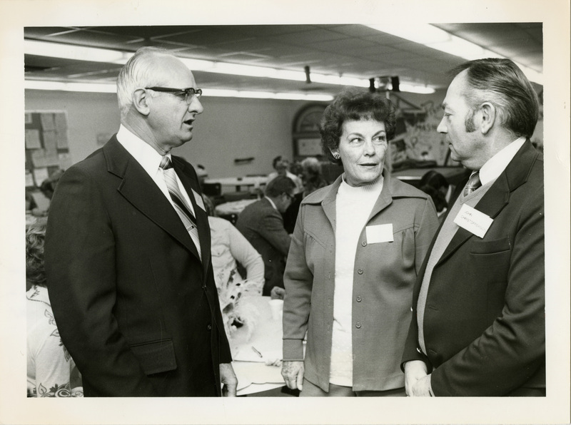 Photo Description: Senator Mark Ricks (R) joins Rep. Elaine Kearnes (R) and someone unknown are talking while visiting Eastern Vocational Technical School. Notes read on back "100% 3x4 Cheers for Elvis with 3:36 Elvis growth"