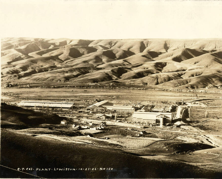 Looking down the hill on to the Lewiston plant. The Clearwater river can been seen behind the mill. The description written on the photo says 'CT CO's Plant, Lewiston Plant 10/27/1926 No. 150.'