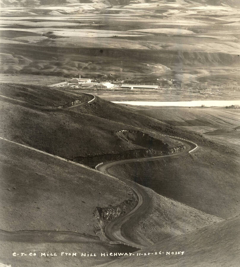 Looking down at the mill from Lewiston Hill. The road that is visible is the Old Spiral Highway. Written on the photograph 'CT CO Mill from Hill Highway 11/26/26 No. 159.'