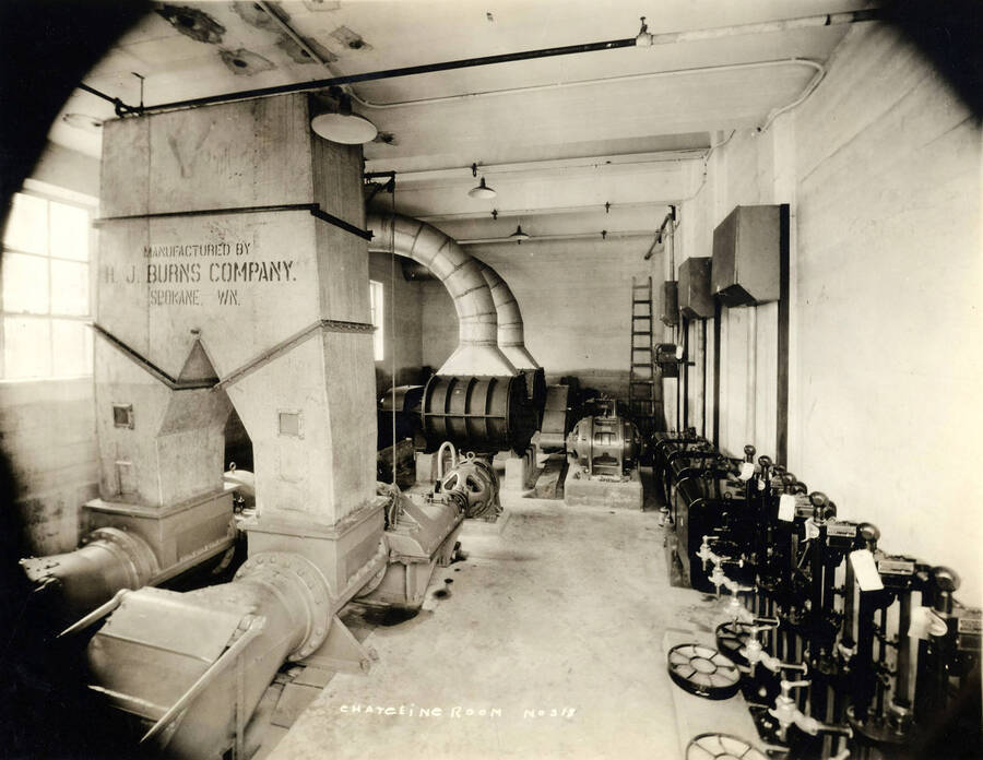 Inside view of the Dry Kiln and Charging room (description taken from back of photograph). Words on one of the machinery read "manufactured by H. J. Burns Company Spokane WN". Written on the photograph is 'Dry Kiln, Charging room, No. 318.'