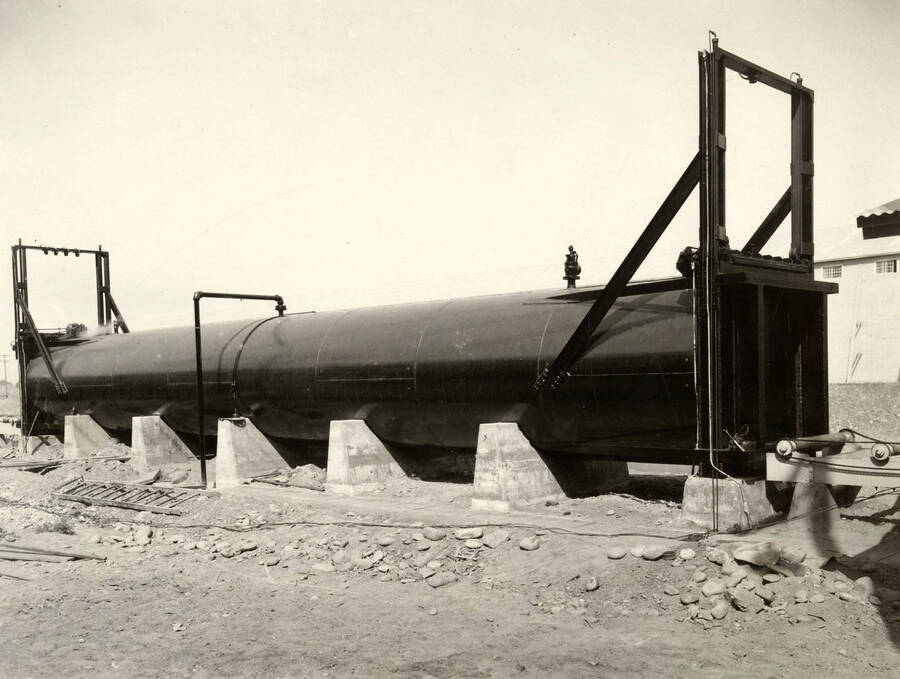 A section of large pipe is under construction at the Lewiston Mill. On the back of the photograph, it is stamped with 'J.F. Anderson, photo Phones 1110-1445J 314 Main St. Lewiston.'