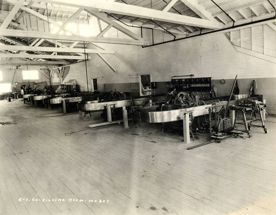Rows of machines fill a room at the Lewiston mill. Written on the photograph says 'CT CO Filing room, No. 307.'