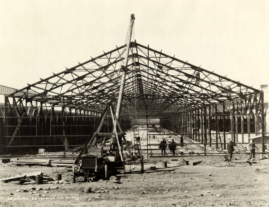 A crane helps in the construction of the loading shed (description taken from writing on the photograph which says 'Loading shed 4/20/1927 No. 204.'