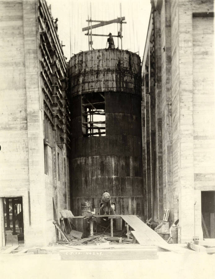 A man works in-between two buildings on another part of the Lewiston Mill that is under construction. Written on the photograph is 'CT CO Plant No. 249.'