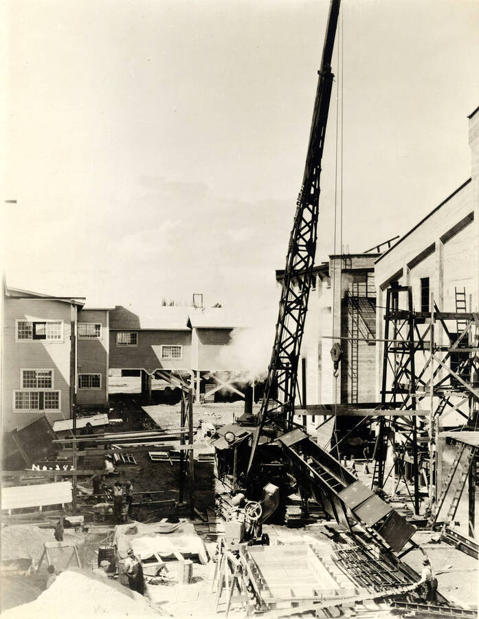 A crane is used to help lift steel parts in helping with construction of the Lewiston Mil. Written on the photograph is 'No. 282.'