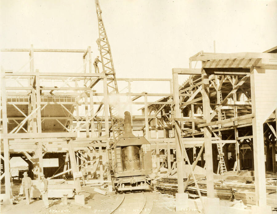 A crane assists in the construction of one of the buildings at the Lewiston Mill. Written on the photograph is 'Stacker and Sorter 1/25/1927 No. 182.'