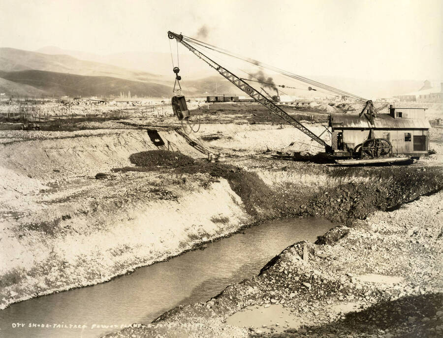 A crane is used on the construction in a part of the Lewiston Mill. Written on the photograph is 'Dry sheds, Tail Race, Power Plant 2/10/1927, No. 199.'