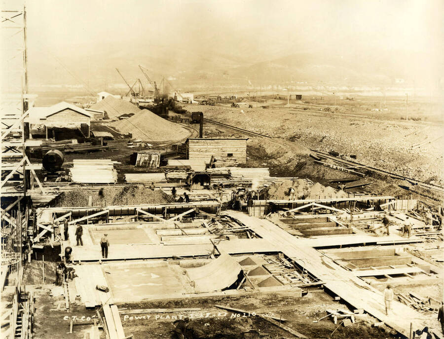 The early stages of the construction of the power plant at the Lewiston Mill. In the background are piles of rock and several locomotive cranes. Written on the photograph is 'CT CO Power Plant 1/28/1927 No. 221.'