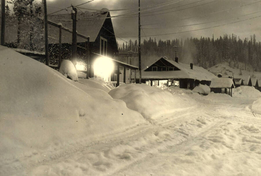Looking down the street in Headquarters, Idaho on the night of January 27, 1943. The snow was between six and seven feet deep and there was a sharp bite to the air that was in no way imaginary (Description taken from board that photo is attached to).