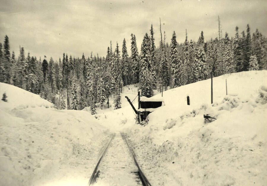 Water tank near old P.F.I Camp 6 -- open area to either side of the railroad permitted the plows to push snow off the tracks with less trouble than elsewhere.'