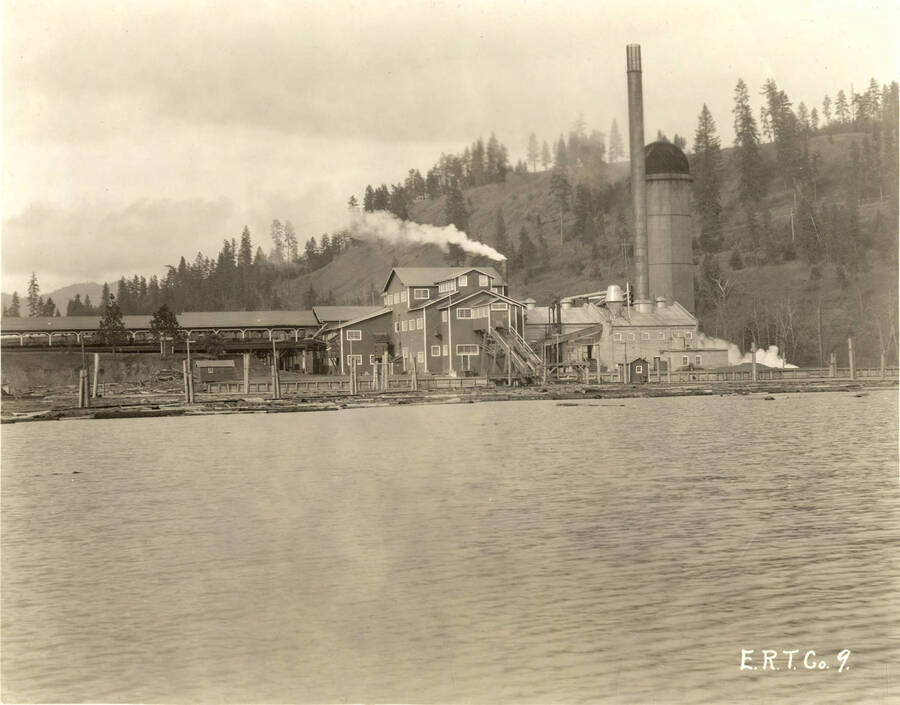Looking from Coeur d'Alene Lake at Rutledge Mill. Written on the back of the photograph is "Edward Rutledge Timber Co. - Coeur d'Alene, Idaho."