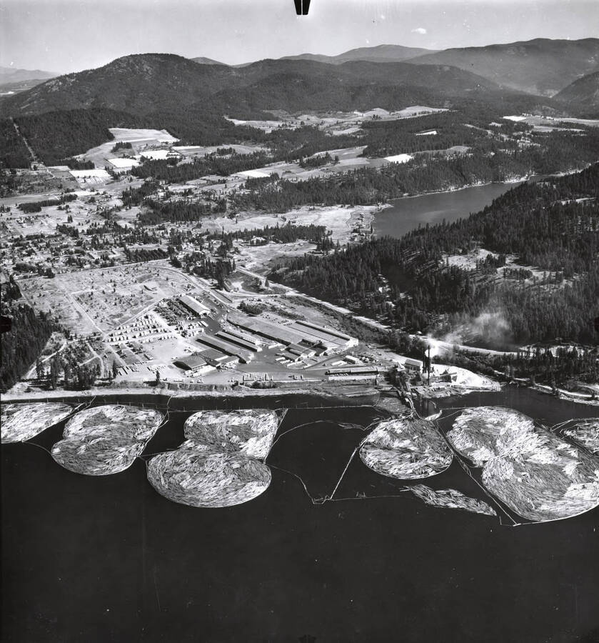 Aerial photograph of the Rutledge Sawmill. Behind the mill is the city of Coeur d'Alene as well as Fernan Lake. Below the mill are the log ponds and Lake Coeur d'Alene. 'Western Ways, Inc. Aerial Photographic Specialists  275 Vera Drive Corvallis Oregon, Phone 35266'