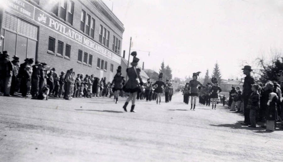 Band marching past Potlatch Mercantile Company