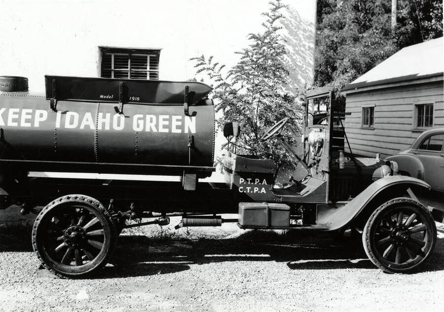 A water truck. Written on the side of the tank is "Keep Idaho Green" and on the side of the cab are the initials "P.T.P.A" (Potlatch Timber Protection Agency) and "C.T.P.A." (Clearwater Protective Association)