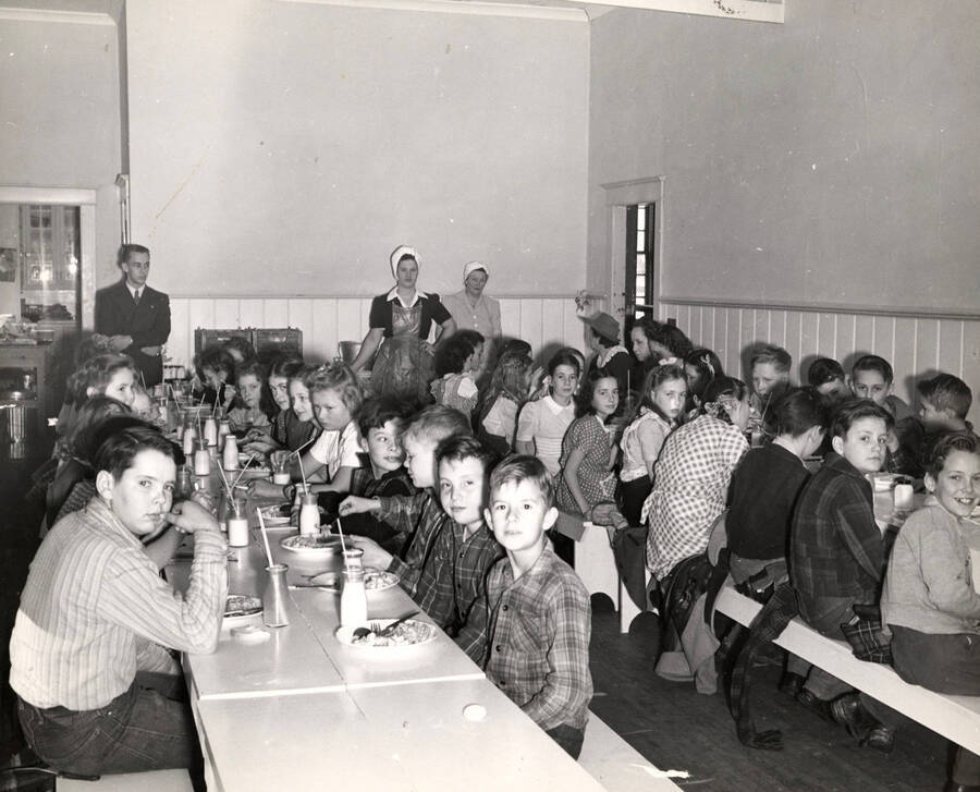 Third and fourth grade students in the school cafeteria.