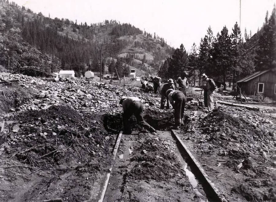 Men clear debris from railroad tracks after the 1948 flood.