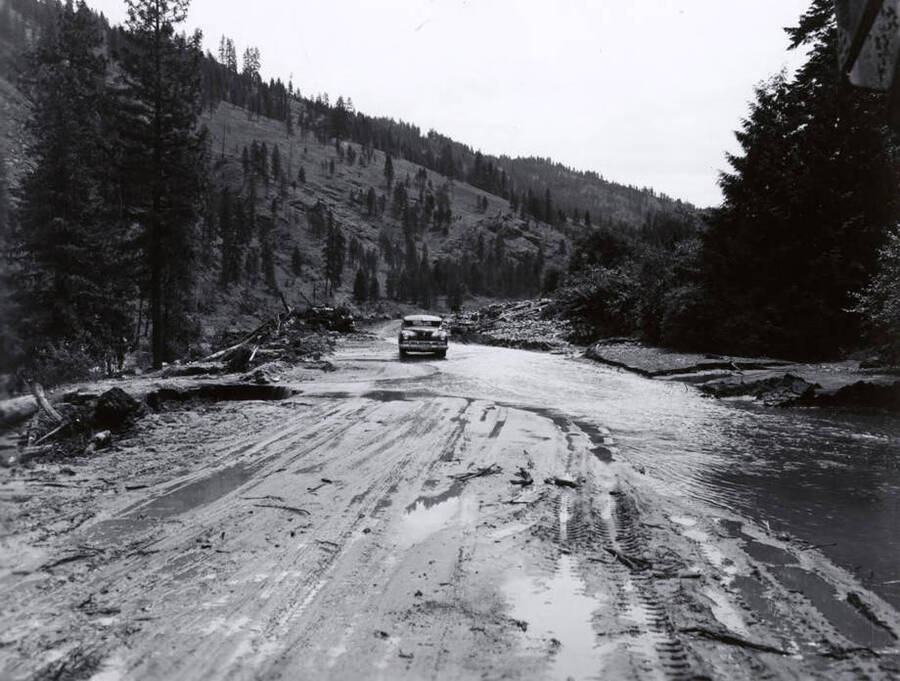 A car sits on a washed out road near the Potlatch Mill.
