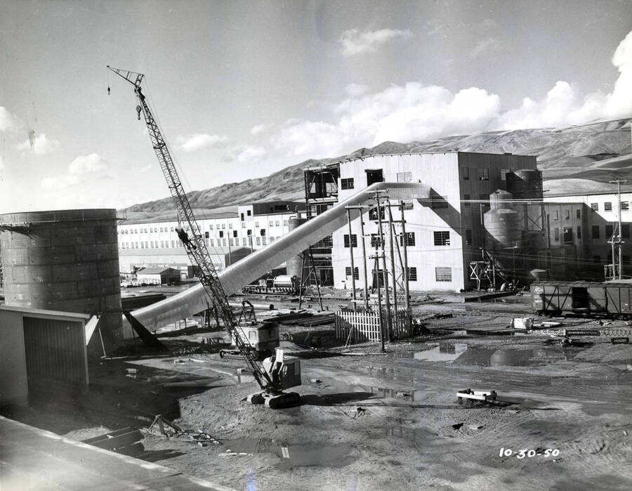 Viewing both recovery and boiler room under construction and the finished main building of the paper mill.