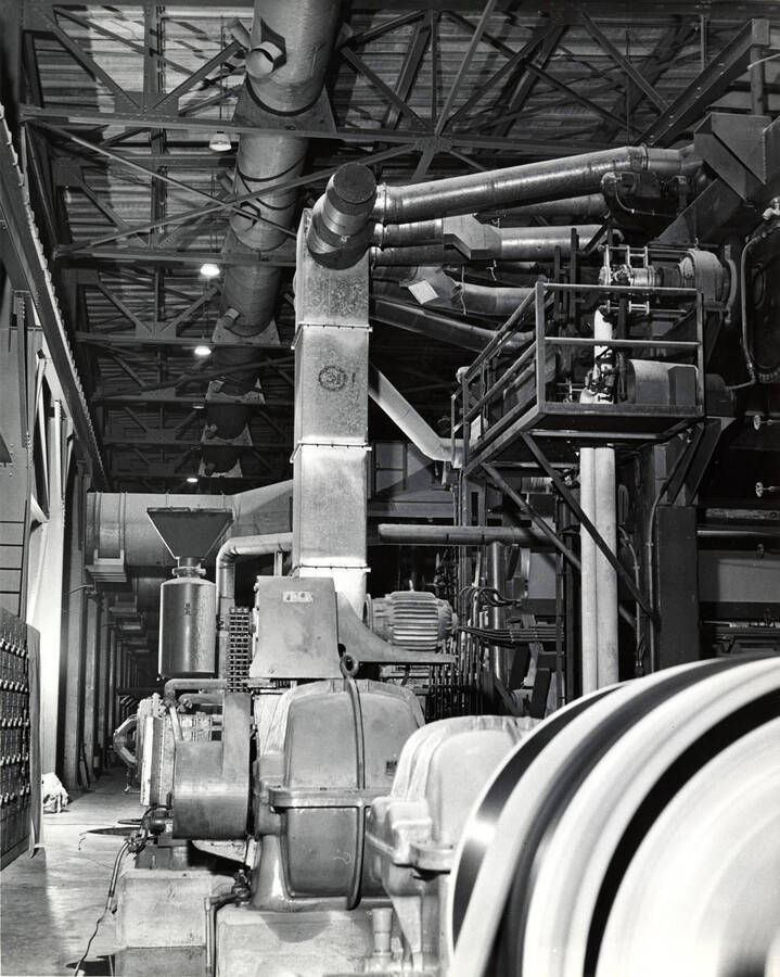Machinery inside the Clearwater Paper Mill plant. On the back of the photograph, it is stamped with the studio name: Bill Jones Photography 6311 S.W. Wilbard St. Portland 19 Oregon. CH 4-4943.