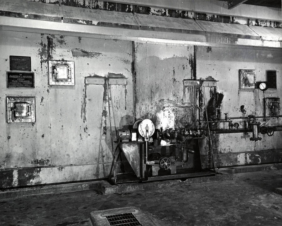 Machinery inside the Clearwater Paper Mill plant. On the left hand side of the photographs there are plaques  on the wall that read Babcock and Wilcox Company [the rest is unreadable]. On the back of the photograph, it is stamped with the studio name: Bill Jones Photography 6311 S.W. Wilbard St. Portland 19 Oregon. CH 4-4943.