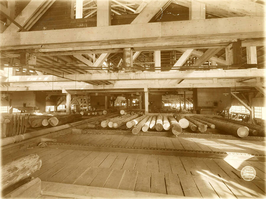 Interior of the saw mill of the Potlatch Lumber Co. at Potlatch, Idaho, from the log end, showing log decks full of logs, four Diamond Iron Works band mills and carriages. (Description taken from American Lumberman papers found within the folder) Photograph taken between September 28 and October 4.
