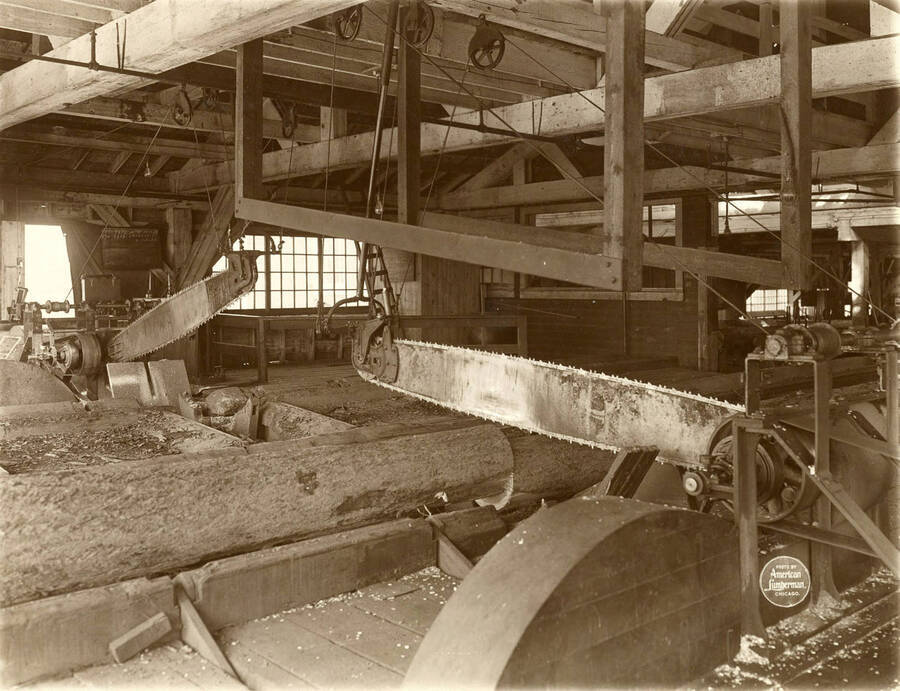 The two International Endless Chain Draw Saws, motor driven. (Description taken from American Lumberman papers found within the folder) Photograph taken between September 28 and October 4.