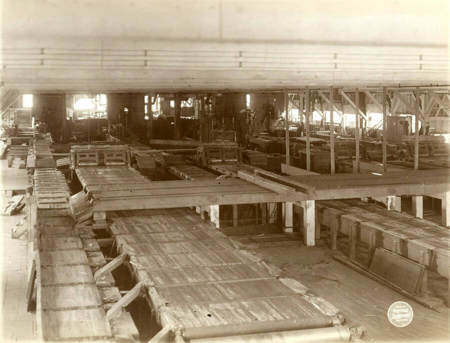  Interior of saw mill from same position, narrower angle showing  details of edgers and bands larger but not including trimmers.' (Description taken from American Lumberman papers found within the folder) Photograph taken between September 28 and October 4.
