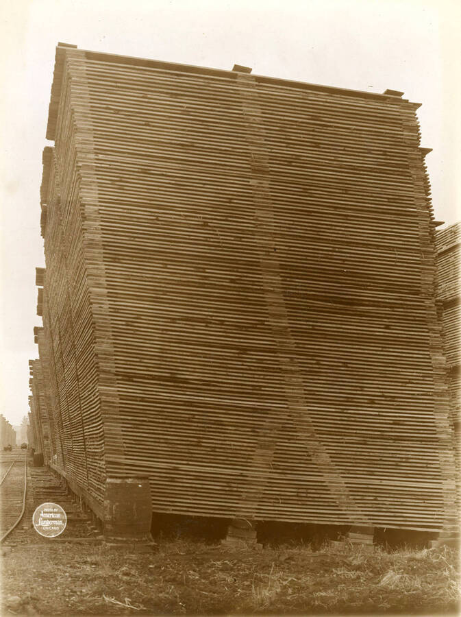 Stack with four bottom supports carried to three cross strips, and north side of Alley No. 20 in lumber yard from east. (Description taken from American Lumberman papers found within the folder) Photograph taken between September 28 and October 4.