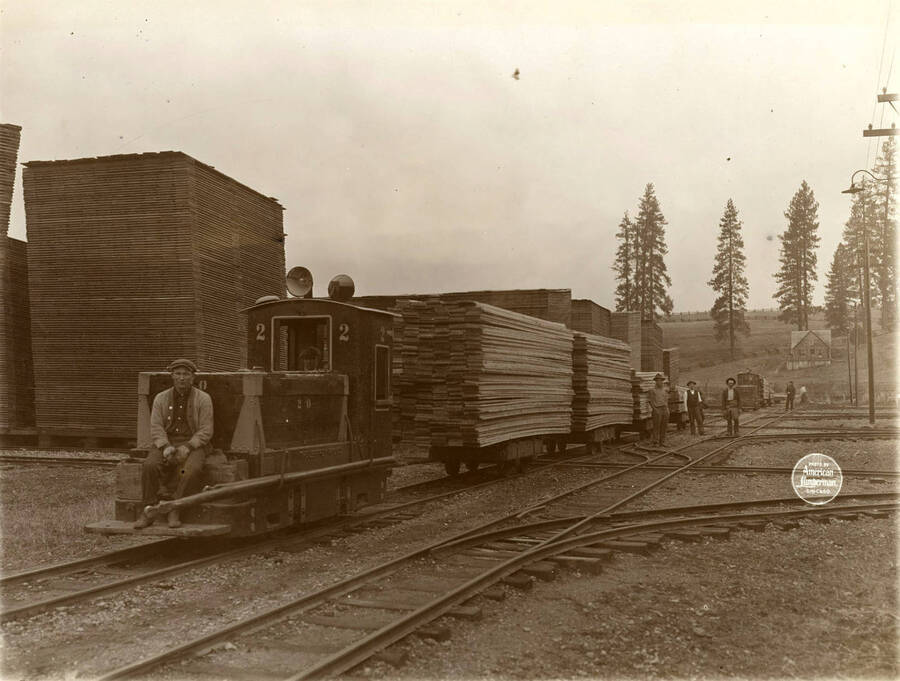 Jeffrey Electric Storage Battery locomotives on main track in yard.' (Description taken from American Lumberman papers found within the folder) Photograph taken between September 28 and October 4.