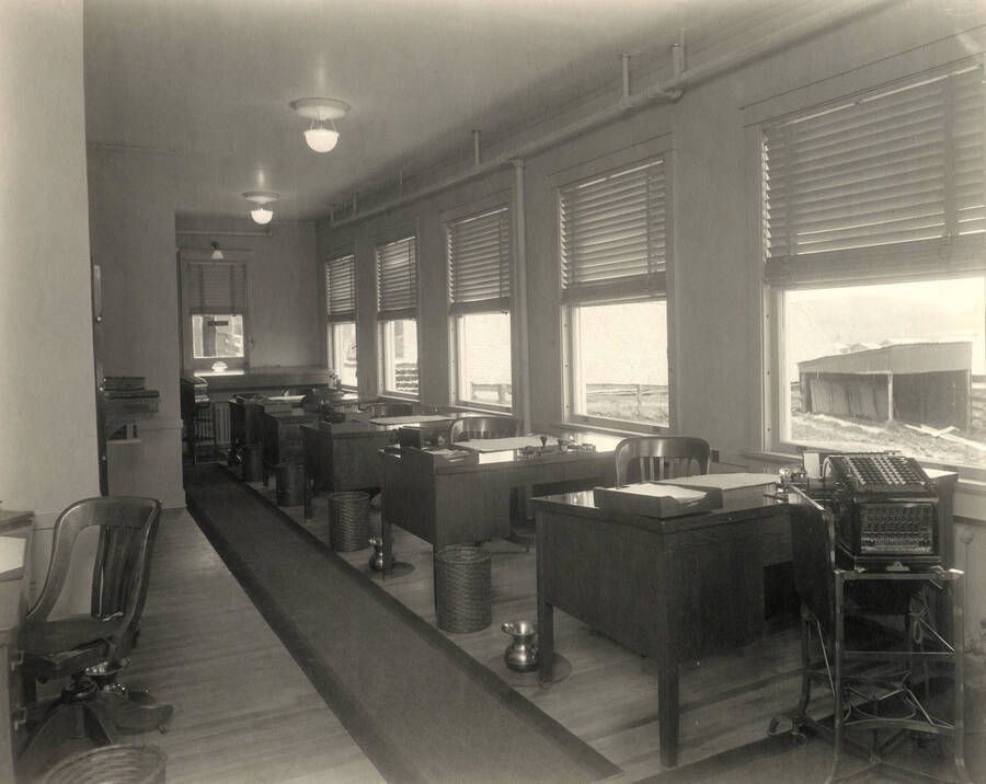 Interior view.  Note old Burroughs adding machine; also spittoons by each desk.