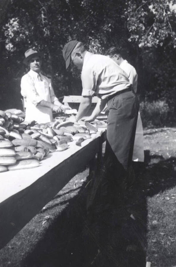John Gano, Albert Moody and Walt Mallory preparing hot dogs for the crowd.
