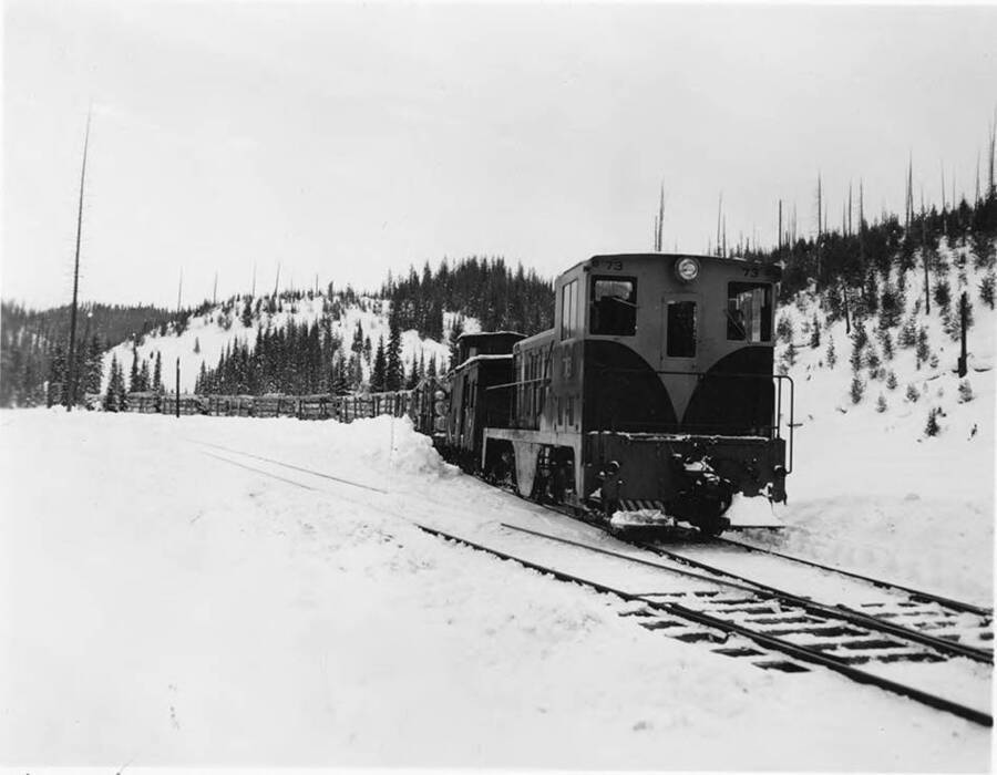 Engine #73 sits on snow-covered railroad tracks in Headquarters, ID.