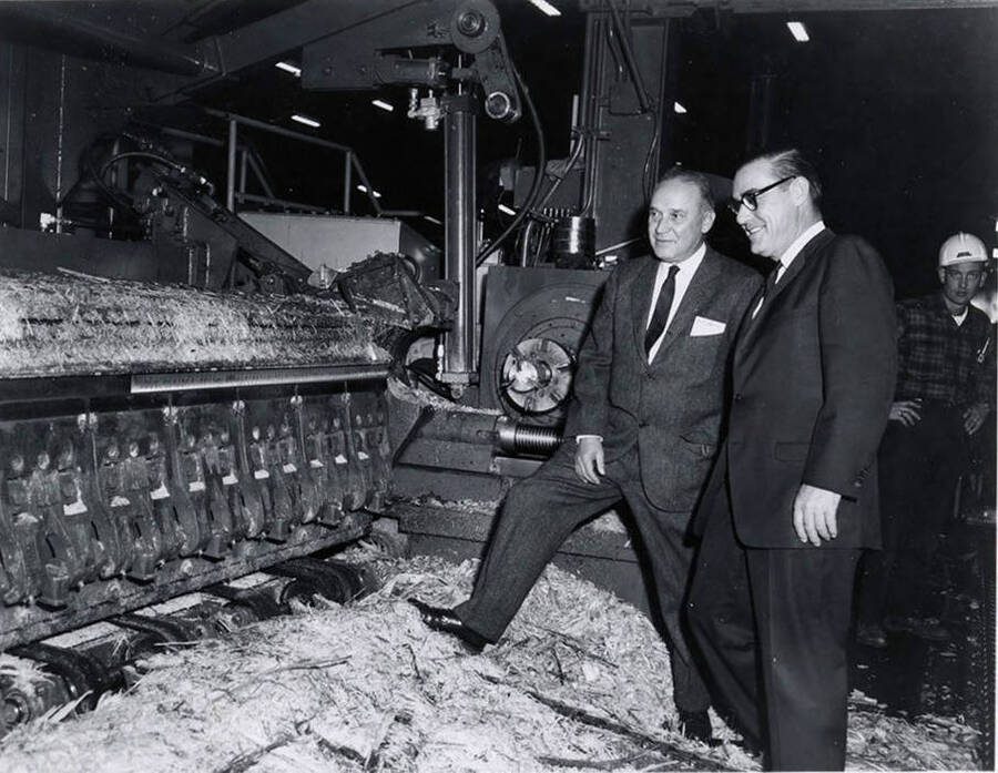 Two men inspect some of the equipment at the Jaype Mill during the dedication.