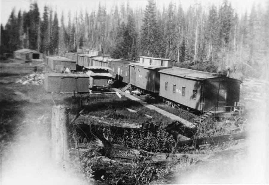 A view of the converted railcars that made up camp C in the Upper Basin. Running alongside the bunkhouses is a wooden walkway.