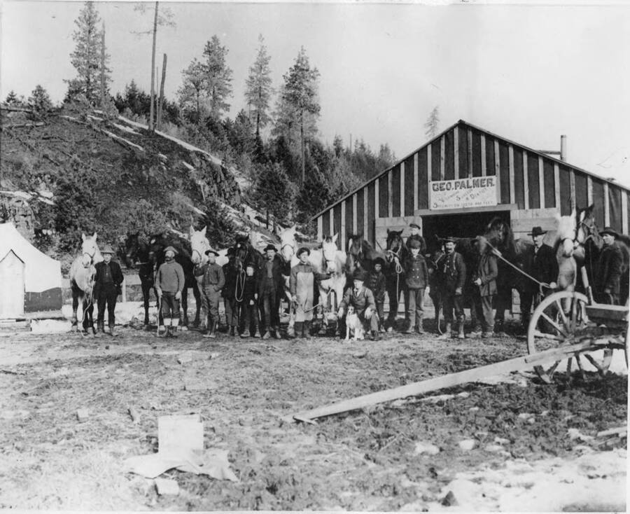 Men pose for a photograph in front a of a barn of George Palmer and the horse hospital in Bovill, Idaho.