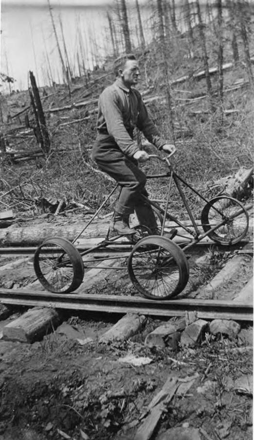 Joack McCleklan rides a four-wheeled vehicle along the train tracks.