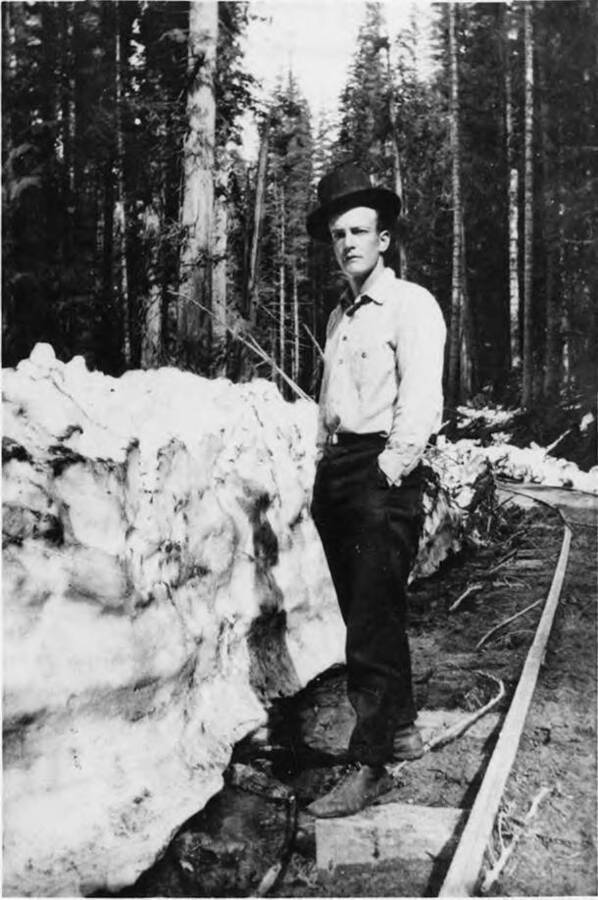 Ezra Warner stands on railroad ties next to snow pack near Elk River, Idaho.