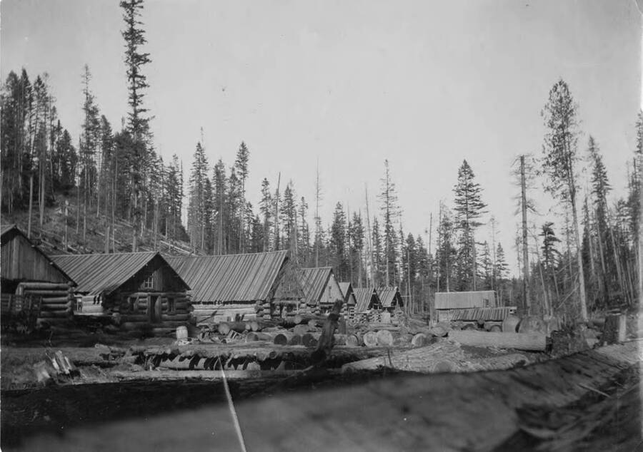 Log cabin bunkhouses are seen at a lumber camp near Harvard, Idaho.