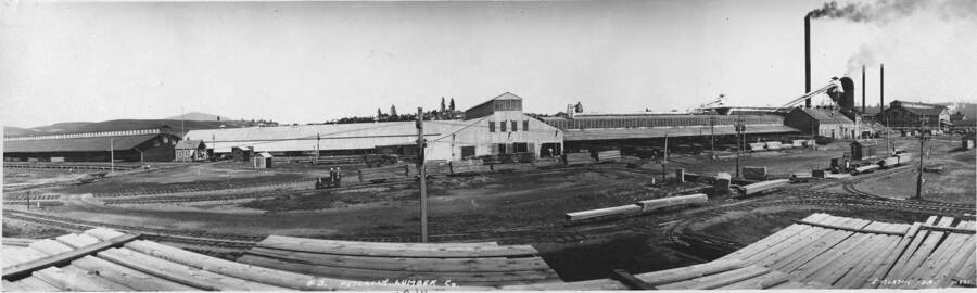 A panoramic view of the mill at Potlatch, Idaho. Written on the back of the photograph 'Engine House, Mill and shed, Main Dry shed on left-Plaver, Center right, Mill far right.' Written on the edge of the photograph is 1914, while written on the picture is 1921.