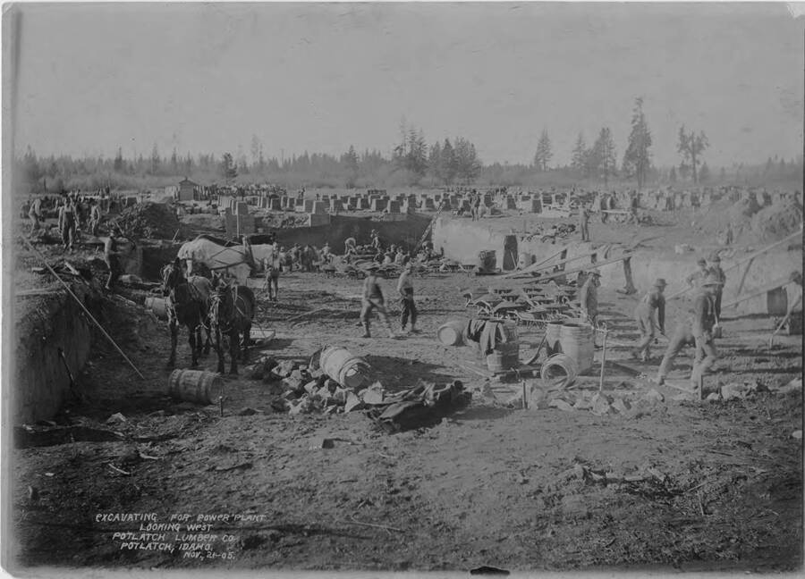 Men work to excavate the ground for the power plant at the Potlatch Mill.  This photo is taken, looking west over the construction site.