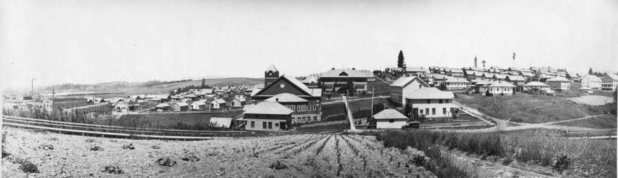 Looking at the residence hill in Potlatch, Idaho. In foreground are a church and school. Just beyond the church is what was then Main street (what is now 6th street).