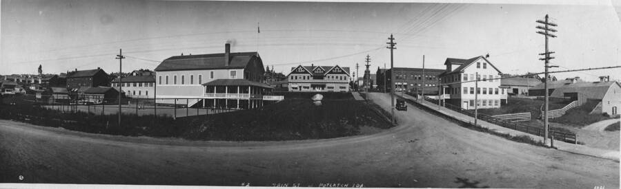 A panoramic view of main street in Potlatch, Idaho. According to the description on the back of the photograph 'Left boarder house hotel. Right office and store'. Written on the photograph is lover right hand corner is the date of 1921 but on the back, the date of 1913 is written.